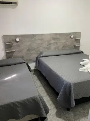 a bedroom with two beds and a headboard at alojamiento bella vista in Villa Carlos Paz