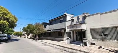 a building on the side of a street at alojamiento bella vista in Villa Carlos Paz