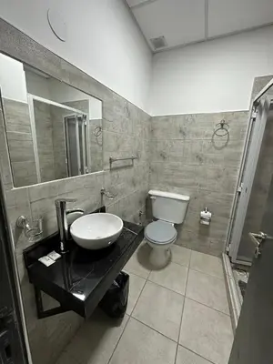 a bathroom with a sink and a toilet at alojamiento bella vista in Villa Carlos Paz