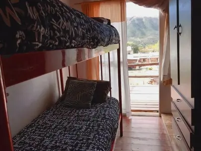 a bedroom with two bunk beds and a balcony at Naiarai Cordoba in Santa María