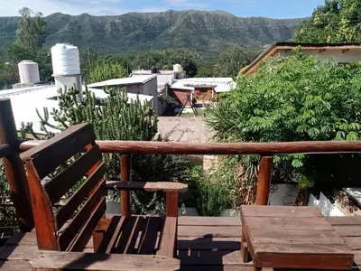 a wooden bench sitting on top of a balcony at Naiarai Cordoba in Santa María