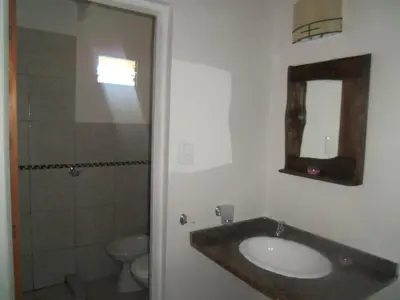 a bathroom with a sink and a toilet and a mirror at Naiarai Cordoba in Santa María