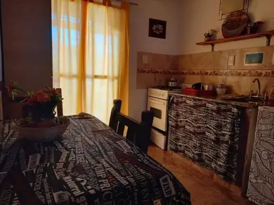 a kitchen with a table and a stove top oven at Naiarai Cordoba in Santa María