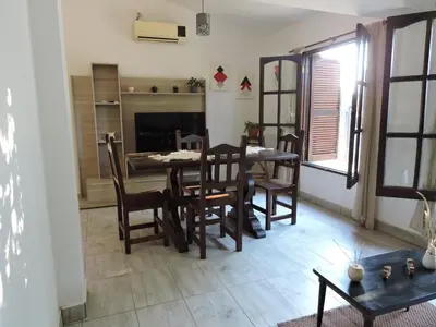 a dining room with a table and chairs and a fireplace at La Casita de Lucía in Almafuerte