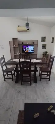 a living room with a table and chairs and a television at La Casita de Lucía in Almafuerte