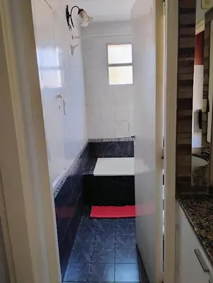 a small bathroom with a red towel on the floor at departamento de excelente ubicación, cochera , aire acondicionado in Villa Carlos Paz