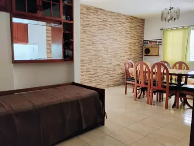 a living room with a table and a dining room at departamento de excelente ubicación, cochera , aire acondicionado in Villa Carlos Paz