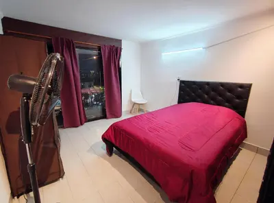 a bedroom with a bed with a red blanket at Departamento luna in Villa Carlos Paz