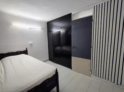 a bedroom with a bed and a black closet at Departamento luna in Villa Carlos Paz