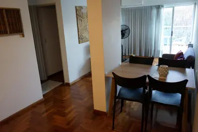 a dining room and living room with a table and chairs at Departamento Nueva Córdoba in Cordoba