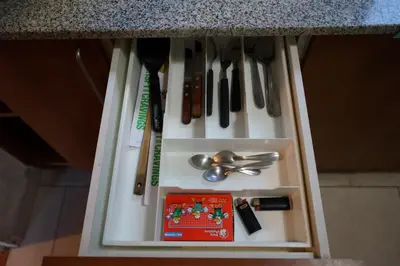 a drawer filled with utensils on a counter at Departamento Nueva Córdoba in Cordoba