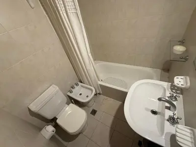a bathroom with a sink and a toilet and a shower at Departamento Nueva Córdoba in Cordoba