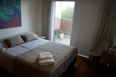 a bedroom with a bed with a towel on it at Departamento Nueva Córdoba in Cordoba