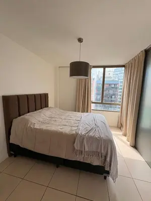 a bedroom with a bed and a large window at Comfort and Convenience Apartment Near Park in Cordoba