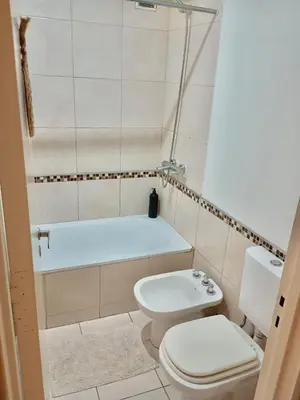 a bathroom with a toilet and a bath tub at Comfort and Convenience Apartment Near Park in Cordoba