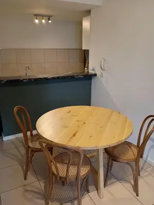 a wooden table and chairs in a kitchen at Comfort and Convenience Apartment Near Park in Cordoba