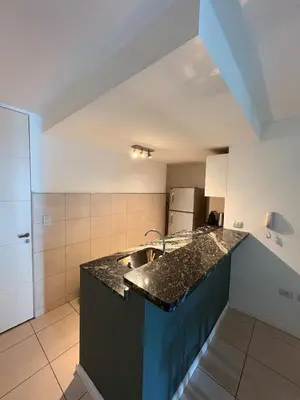 a kitchen with a sink and a counter top at Comfort and Convenience Apartment Near Park in Cordoba