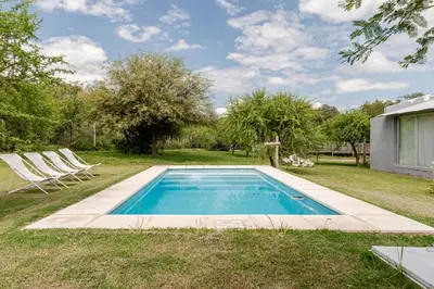a swimming pool in the yard of a house at Casa con piscina privada y vistas al Cerro Champaquí in San Javier