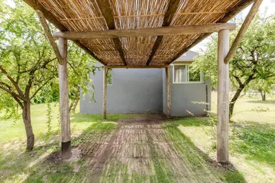 a wooden pavilion in a yard with trees at Casa con piscina privada y vistas al Cerro Champaquí in San Javier