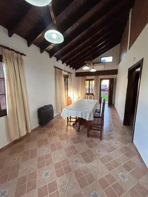 a dining room with a white table and chairs at Casa Fiorenza in Merlo
