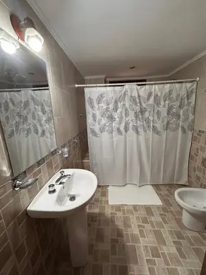 a bathroom with a sink and a shower and a toilet at Casa Fiorenza in Merlo