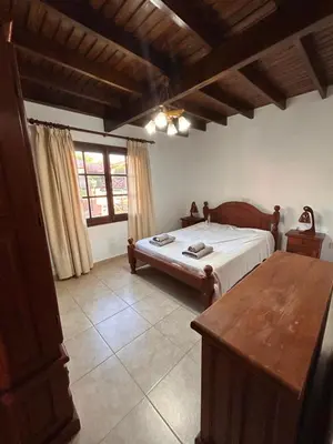 a bedroom with a bed and a table in it at Casa Fiorenza in Merlo