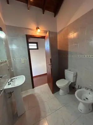 a bathroom with a toilet and a sink at Casa Fiorenza in Merlo