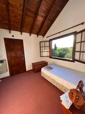 a bedroom with a bed and a large window at Casa Fiorenza in Merlo