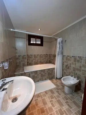 a bathroom with a sink and a tub and a toilet at Casa Fiorenza in Merlo