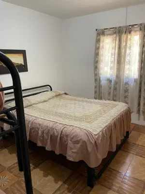 a bedroom with a bed and a window at Depto Sierra in Santa Rosa de Calamuchita