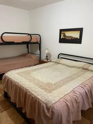 a bedroom with two bunk beds and a table at Depto Sierra in Santa Rosa de Calamuchita