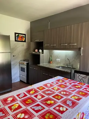 a kitchen with a table with a tablecloth on it at Depto Sierra in Santa Rosa de Calamuchita