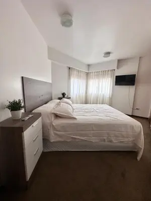 a bedroom with a large bed and a window at Departamento premium, Patio Olmos shopping !! in Cordoba