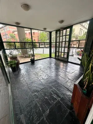 an empty room with a large window and plants at Departamento premium, Patio Olmos shopping !! in Cordoba