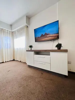 a living room with a flat screen tv on a wall at Departamento premium, Patio Olmos shopping !! in Cordoba