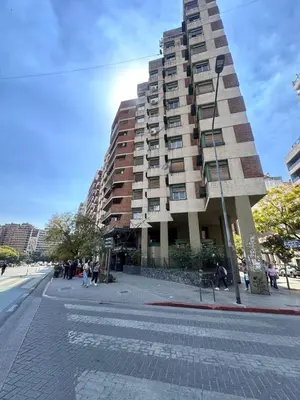 a tall building on a street in front of a building at Departamento premium, Patio Olmos shopping !! in Cordoba