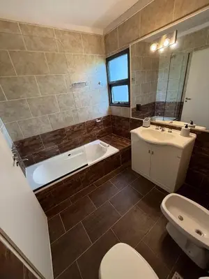 a bathroom with a tub and a toilet and a sink at Nomad Base en Country Chumamaya in Merlo