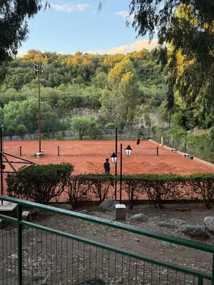 a park with a dirt field with people playing golf at Nomad Base en Country Chumamaya in Merlo