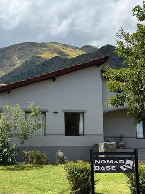 a white house with a sign in front of it at Nomad Base en Country Chumamaya in Merlo