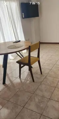 a wooden table and a bench next to a table and chair at La Terraza in Cordoba