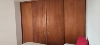 a wooden cabinet in a bedroom with a bed at La Terraza in Cordoba