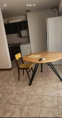 a wooden table and a chair in a kitchen at La Terraza in Cordoba