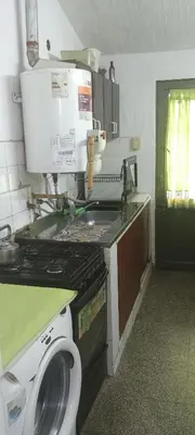 a kitchen with a sink and a washing machine at Casa de la Nona in Cordoba