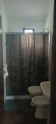 a bathroom with a toilet and a shower curtain at Casa de la Nona in Cordoba