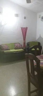 a room with two beds and a table and a chair at Casa de la Nona in Cordoba
