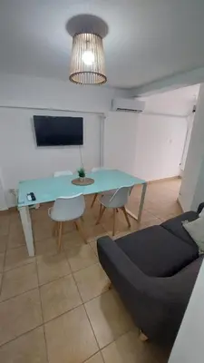 a living room with a blue table and a couch at Dpto Genoma Lounge in Cordoba