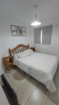 a bedroom with a bed and a chair in it at Dpto Genoma Lounge in Cordoba