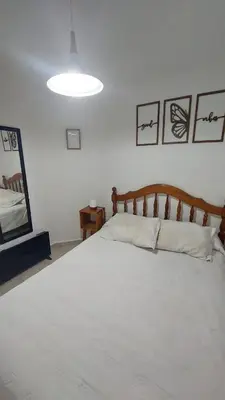 a bedroom with a large white bed in a room at Dpto Genoma Lounge in Cordoba