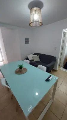 a blue table in a living room with a couch at Dpto Genoma Lounge in Cordoba