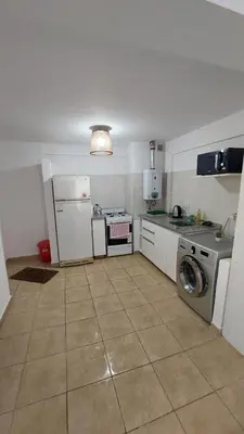 a kitchen with a washing machine and a washer at Dpto Genoma Lounge in Cordoba